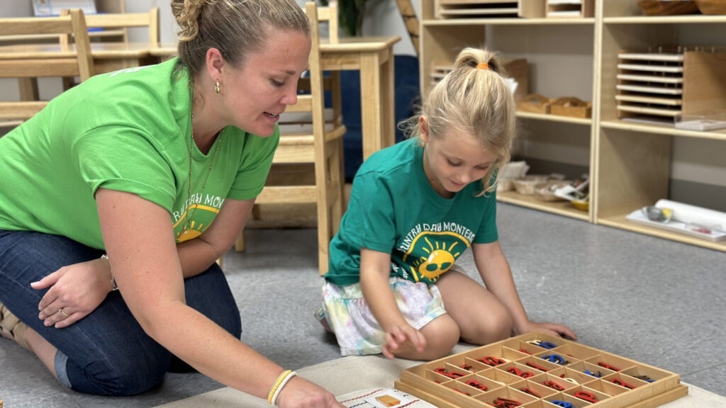 country day montessori teacher guiding child