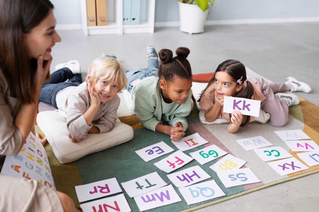 young woman doing speech therapy with children